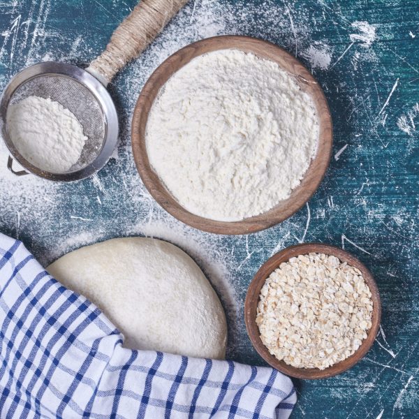Bread dough with ingredients on blue background. High quality photo