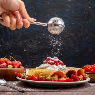 front-view-yummy-rolled-pancakes-with-cranberries-fresh-red-strawberries-getting-sugar-powder-wooden-desk-meal-fruit-berry